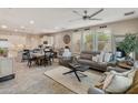 Bright and airy living room with neutral tones, modern furnishings, and an open layout connecting to the kitchen at 31061 N 136Th Ln, Peoria, AZ 85383