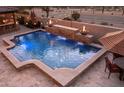 Inviting pool with travertine surround, fire bowls and cascading water feature at 31816 N 19Th Ave, Phoenix, AZ 85085