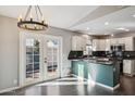 Bright kitchen with white cabinets, dark countertops, stainless steel appliances, and glass patio doors at 3311 W Baylor Ln, Chandler, AZ 85226