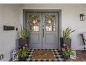 Inviting double front doors adorned with wreaths, planters, and a welcome mat create a warm entrance at 4225 N 42Nd St, Phoenix, AZ 85018