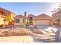 Charming single-story home with a well-manicured rock yard, desert landscaping, and a two-car garage at 42829 W Oakland Dr, Maricopa, AZ 85138