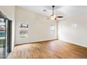 Bright living room with hardwood floors, ceiling fan, and multiple windows at 44025 N 44Th Ln, New River, AZ 85087