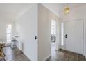 Bright foyer with tile floors, white walls, and a view to the breakfast nook at 4814 E Pearce Rd, Phoenix, AZ 85044