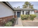 Inviting front entrance with a blue front door and well-maintained landscaping at 4814 E Pearce Rd, Phoenix, AZ 85044