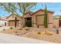 Charming single-Gathering home showcasing desert landscaping with cacti, gravel, and a mature tree at 5948 W Leiber Pl, Glendale, AZ 85310