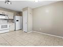 Eat in kitchen features white appliances, and tiled flooring at 7147 S Morning Dew Ln, Buckeye, AZ 85326