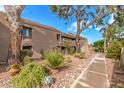 Charming exterior of a multi-story home with well-maintained landscaping and mature trees at 7428 N Via Camello Del Norte -- # 182, Scottsdale, AZ 85258