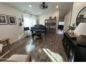 Open living room boasts hardwood floors, piano, and decor that creates a warm and inviting space at 853 E Ross Ave, Phoenix, AZ 85024