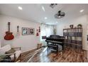 Bright living room features wood floors, a piano, ample lighting, and a cozy seating arrangement at 853 E Ross Ave, Phoenix, AZ 85024