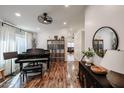 Bright living room features wood floors, a piano, ample lighting, and a view through to a connected room at 853 E Ross Ave, Phoenix, AZ 85024