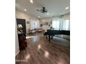 Bright living room featuring hardwood floors, a piano and cello, and an abundance of natural light at 853 E Ross Ave, Phoenix, AZ 85024