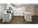 Bright kitchen featuring stainless steel appliances, white cabinets, countertops, and sleek hardware at 909 W San Mateo Ct, Gilbert, AZ 85233