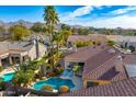 Aerial view of a private backyard pool, lounge chairs, and beautiful landscaping at 9160 E Wethersfield Rd, Scottsdale, AZ 85260