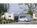 Modern home featuring a two car garage, stucco siding, desert landscaping, and a circular driveway at 9611 E Clinton St, Scottsdale, AZ 85260