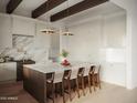 Bright, modern kitchen featuring a large island with seating, custom cabinets, and designer fixtures at 9611 E Clinton St, Scottsdale, AZ 85260