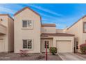 Charming two-story townhome featuring a front-facing garage and low-maintenance gravel landscaping at 1018 W Libra Dr, Tempe, AZ 85283