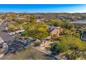 Beautiful home surrounded by well-kept desert landscaping, with a charming neighborhood backdrop at 11415 E Four Peaks Rd, Scottsdale, AZ 85262