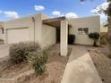 Charming single-story home with a two-car garage, and a well-maintained front yard at 11609 N 30Th Ln, Phoenix, AZ 85029