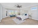 A large bedroom with neutral carpet, recessed lighting, and sitting area next to large windows at 1644 N Lynch --, Mesa, AZ 85207