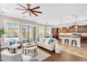 Inviting living room with high ceilings, large windows, and an open layout to the kitchen and dining area at 1644 N Lynch --, Mesa, AZ 85207