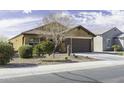 Single-story home boasts a xeriscaped front yard with a two-car garage and inviting curb appeal at 1973 N Lewis Pl, Casa Grande, AZ 85122
