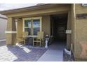 Welcoming front porch with rocking chairs, decorative accents, and a charming entrance at 1973 N Lewis Pl, Casa Grande, AZ 85122