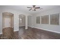 Bright living room featuring hardwood floors, light neutral walls, and ample natural light at 2486 E Espada Trl, Casa Grande, AZ 85194