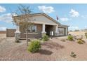 Inviting home with desert landscaping, featuring a covered front porch and classic architectural design elements at 26388 N 77Th Dr, Peoria, AZ 85383