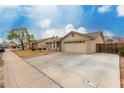 Charming single-level home featuring a tile roof and a well-maintained front yard and a long driveway at 2975 E Tulsa St, Gilbert, AZ 85295