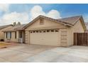 Charming single-level home featuring a tile roof and a well-maintained front yard and large garage at 2975 E Tulsa St, Gilbert, AZ 85295