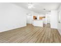 Open living space with wood-look flooring, seamlessly connecting to the kitchen and dining areas at 41176 N Cambria Dr, San Tan Valley, AZ 85140