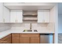 Close up on kitchen countertops featuring stainless steel dishwasher and stylish cabinets at 4201 E Camelback Rd # 28, Phoenix, AZ 85018