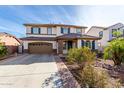 Charming two-story home with a desert landscape, two-car garage, and tile roof at 4727 S Watauga Dr, Gilbert, AZ 85297