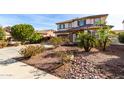 Desert-landscaped front yard with lush plants and stone accents in front of the home at 4727 S Watauga Dr, Gilbert, AZ 85297