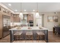 Modern kitchen features stainless steel appliances, a large island, and stylish pendant lighting at 5250 E Deer Valley Dr # 246, Phoenix, AZ 85054