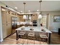 Stylish kitchen featuring modern stainless steel appliances, a center island, and ample cabinet space at 5250 E Deer Valley Dr # 246, Phoenix, AZ 85054