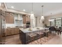 Open concept kitchen with a large island, modern appliances, and a view of the dining area at 5250 E Deer Valley Dr # 246, Phoenix, AZ 85054