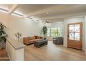Bright and airy living room with hardwood floors, exposed beams and a decorative ceiling fan at 5650 E Presidio Rd, Scottsdale, AZ 85254