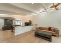 Spacious living room with beamed ceilings, hardwood floors, and an open layout at 5650 E Presidio Rd, Scottsdale, AZ 85254