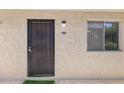 The front door to unit 110A features a decorative security door and is next to a window at 7625 E Camelback Rd # A110, Scottsdale, AZ 85251