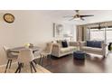 Inviting living room featuring hardwood floors, a ceiling fan, and stylish neutral-toned furniture at 7625 E Camelback Rd # A110, Scottsdale, AZ 85251