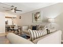 Comfortable living room offering a ceiling fan, natural light, and seamless access to the kitchen at 7625 E Camelback Rd # A110, Scottsdale, AZ 85251