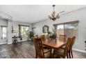 Dining area with chandelier, wood table, and ample natural light at 10359 E Jacob Ave, Mesa, AZ 85209