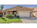 Inviting single-story home featuring a two-car garage, well-manicured lawn, and desert landscaping at 10359 E Jacob Ave, Mesa, AZ 85209