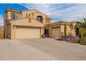 Spacious home featuring a three-car garage with ample parking and desert landscaping at 10434 E Jacob Ave, Mesa, AZ 85209