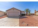 Charming single-story home with a two-car garage and desert landscaping at 10659 W Yukon Dr, Peoria, AZ 85382