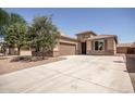 Single-story home with a wide driveway, two-car garage, and desert landscaping in front at 10859 E Thatcher Ave, Mesa, AZ 85212
