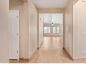 Hallway with wood-look tile flooring leading to the spacious main living area at 10859 E Thatcher Ave, Mesa, AZ 85212