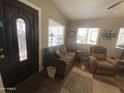 Welcoming entryway with a decorative door leading into a sunlit living space at 1277 S Shawnee Dr, Apache Junction, AZ 85119