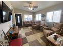 Bright living room featuring a plush sofa, recliner chairs, and natural light from large windows at 1277 S Shawnee Dr, Apache Junction, AZ 85119